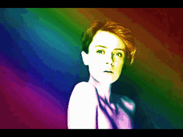 a pixelated image of a woman with a rainbow colored background