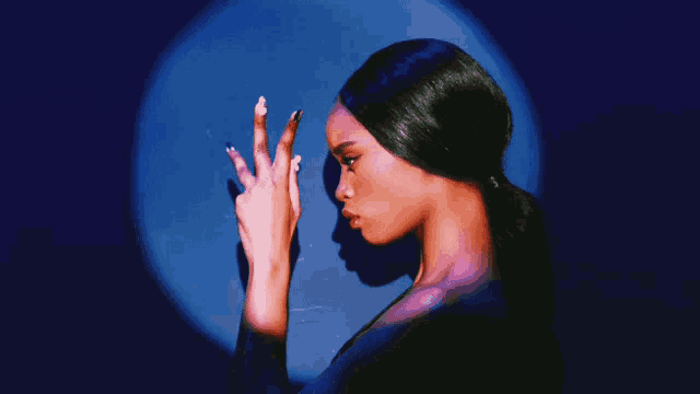 a woman with long nails is looking down at something