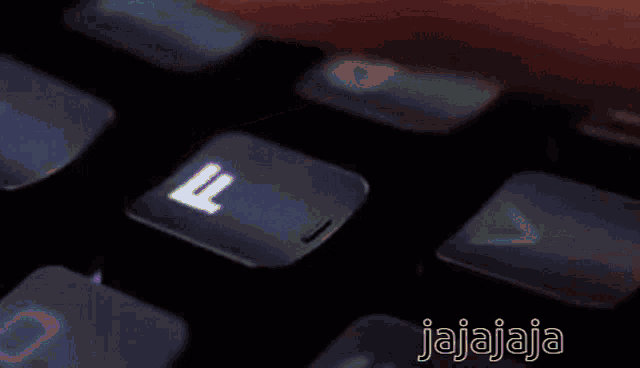 a close up of a person pressing a key on a keyboard that says ' jajajaja ' on the bottom