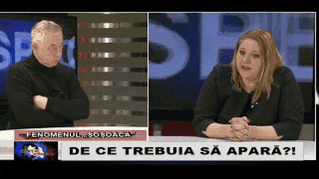 a man and a woman are sitting in front of a sign that says de ce trebuia sa apară