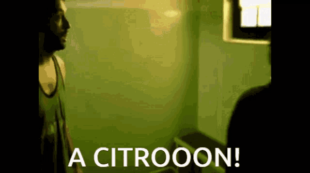 a man is standing in a green room with the words " a citrooon " on the bottom