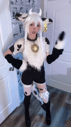 a girl in a cow costume stands in front of a door with a yellow tag that says 106