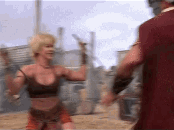 a woman is kneeling down with a sword in her hand