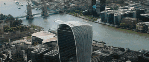 an aerial view of a city with a large building in the middle