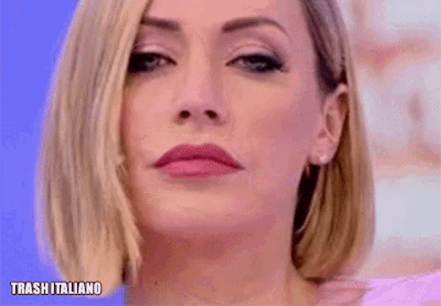 a close up of a woman 's face with the words trash italiano written below her .