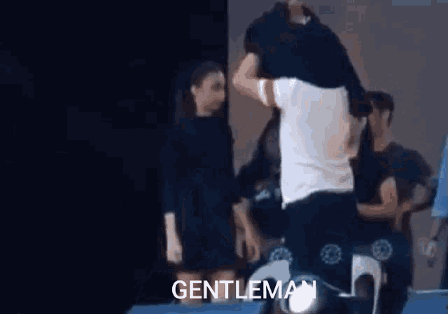 a man is carrying another man on his shoulders and the word gentleman is on the bottom of the screen
