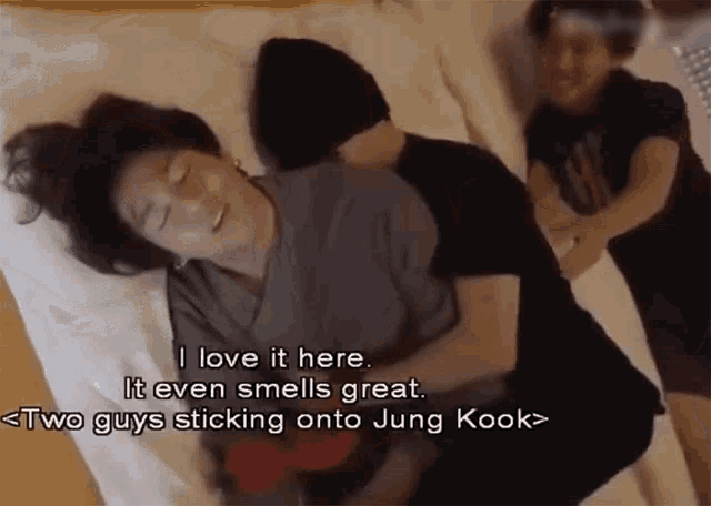 a person laying on a bed with the words i love it here
