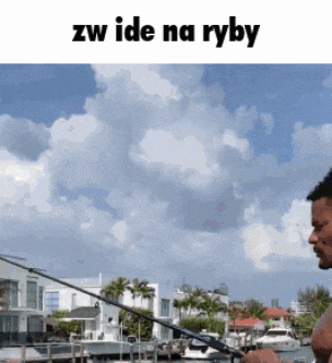 a man is fishing in a harbor with the words " zw ide na ryby " below him
