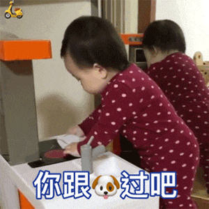 a baby in a red and white polka dot pajama is playing with a toy kitchen .
