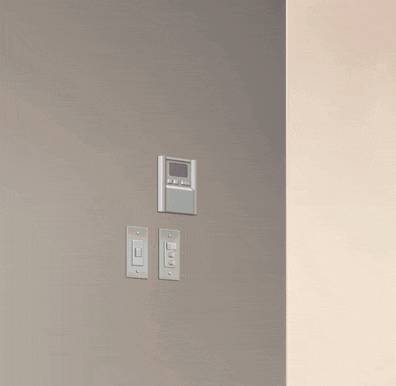 a girl peeking out from behind a wall with two electrical outlets on it