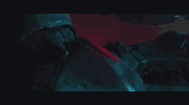 a green armored soldier is laying on the ground in the dark