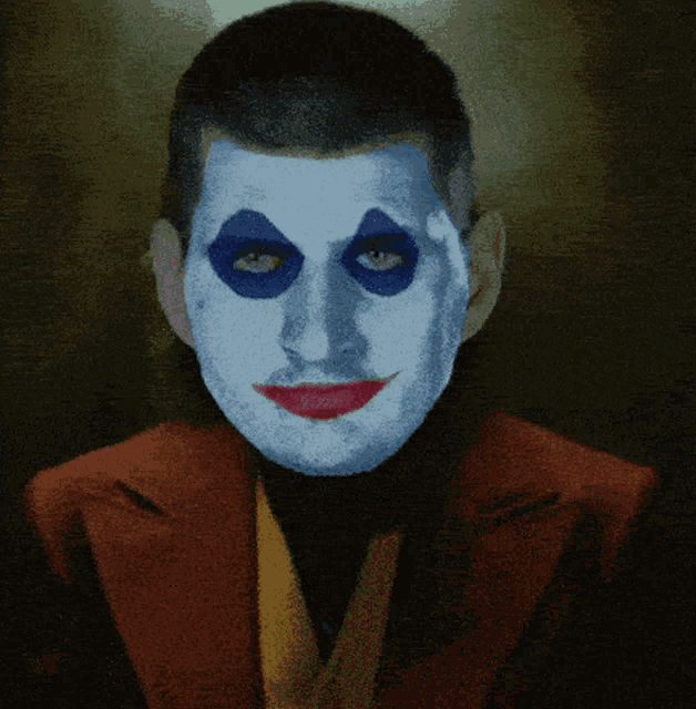 a man with blue eyes and white face paint