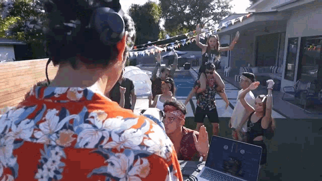 a man wearing headphones stands in front of a group of people dancing