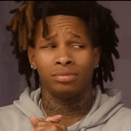 a man with dreadlocks and a tattoo on his neck is making a sad face