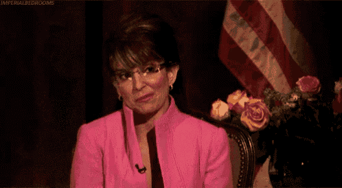 a woman in a pink suit is smiling and says you 're welcome in yellow letters
