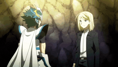 a man in a white cape stands next to a man in a black suit