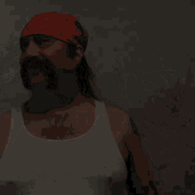 a man with a mustache and ponytail wearing a red bandana and a white tank top