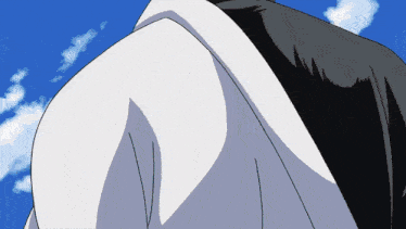 a close up of a person 's shoulder with a blue sky behind them