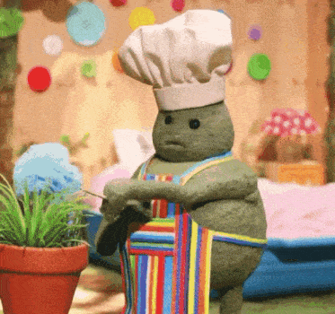 a stuffed animal with a chef 's hat and apron