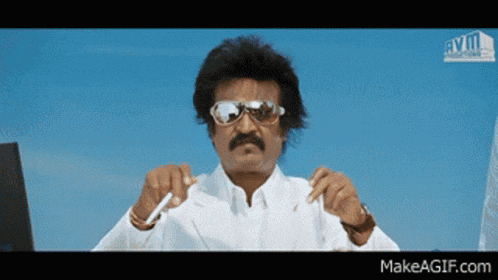 a man with a mustache is wearing sunglasses and holding a pen in his hand