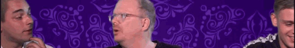 a group of men are standing in front of a purple background