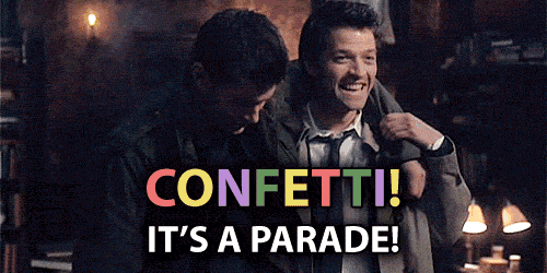 a couple of men standing next to each other with the words confetti it 's a parade