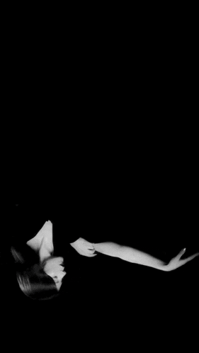 a black and white photo of a woman in a dress