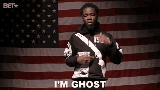 a man standing in front of an american flag with the words i 'm ghost