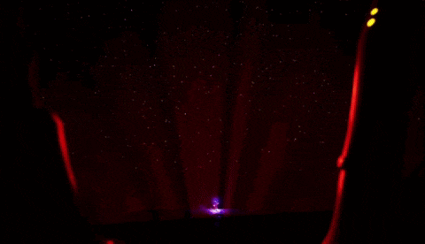 a cartoon character with glowing eyes is standing in a dark room