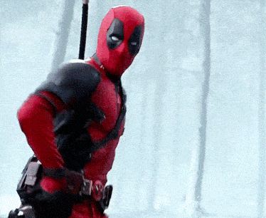 a man in a deadpool costume is standing in a forest