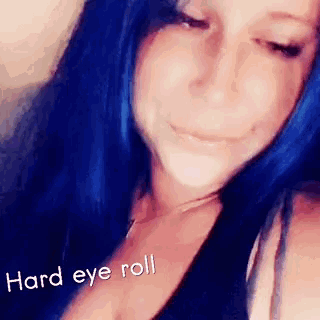 a woman with blue hair is taking a selfie with the words `` hard eye roll '' .