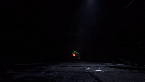 a dark room with a glowing green object in the middle
