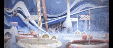 a woman is riding a bike in a candy land .