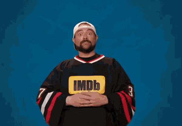 a man in a imdb jersey holds a life preserver in his hands