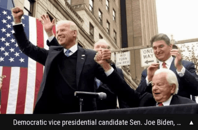 democratic vice presidential candidate sen. joe biden holds his fist up in the air