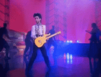 a man is playing a guitar on stage in front of a piano
