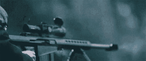 a man is holding a sniper rifle in his hand and shooting it in the dark .