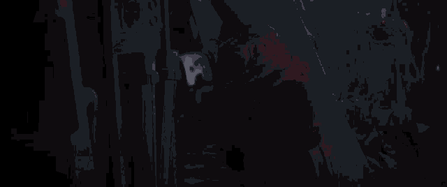 a baby yoda is standing in the snow holding a lightsaber in a dark room .