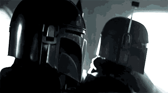 a couple of people wearing helmets are standing next to each other .