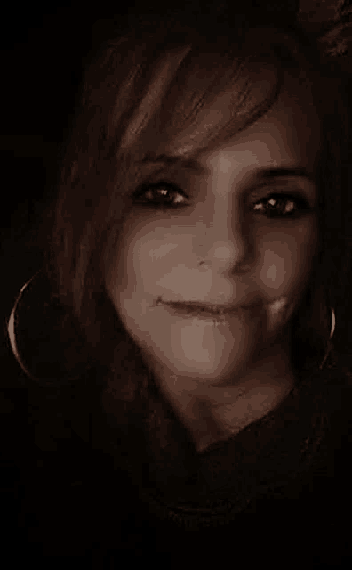 a close up of a woman 's face with a smile on her face .