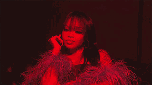 a woman in a red and blue feathered outfit is talking on a cell phone