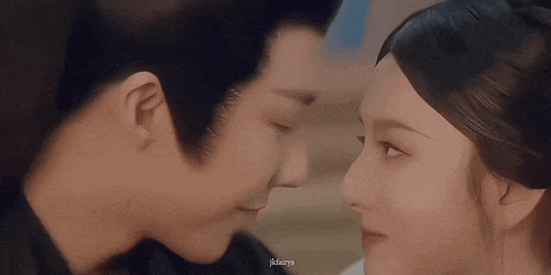 a man and a woman are looking at each other 's faces .