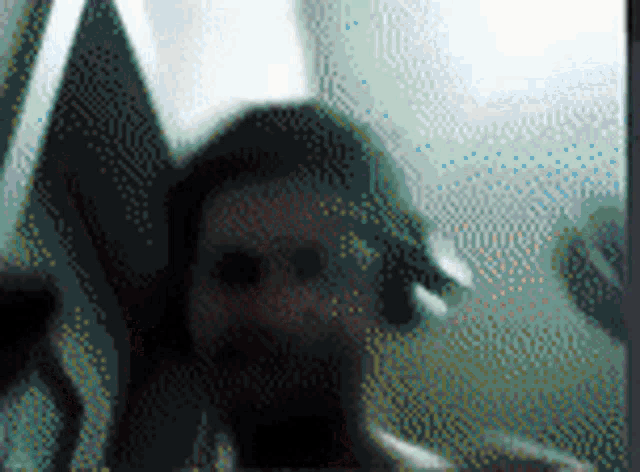 a blurred image of a person 's face with a hat on