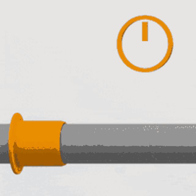 an orange clock is above a pipe with a yellow ring on it