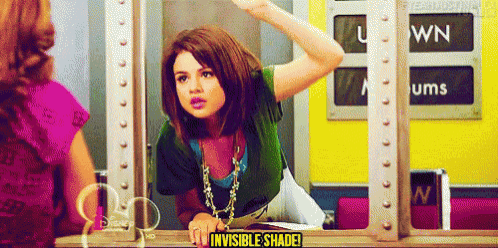 a girl is looking at herself in a mirror with the words invisible shade written on it