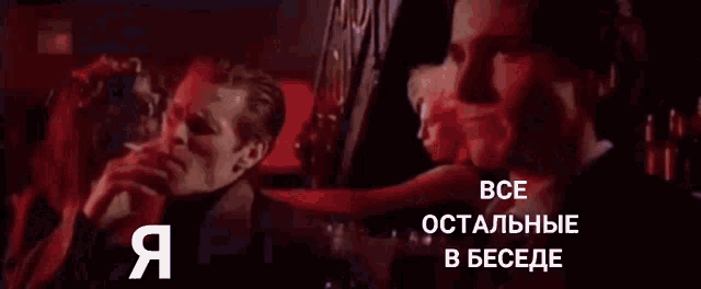 a man in a suit and tie is talking to another man in a dark room in a foreign language ..