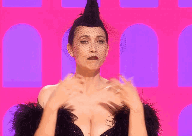 a woman with a mohawk and a veil on her head is standing in front of a pink and purple background