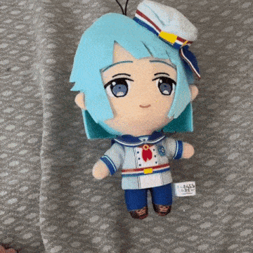 a stuffed toy of a boy with blue hair and a sailor outfit