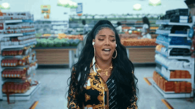 a woman is singing in a grocery store