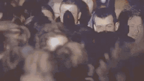 a crowd of people at a concert holding up a sign that says " keep dancing "